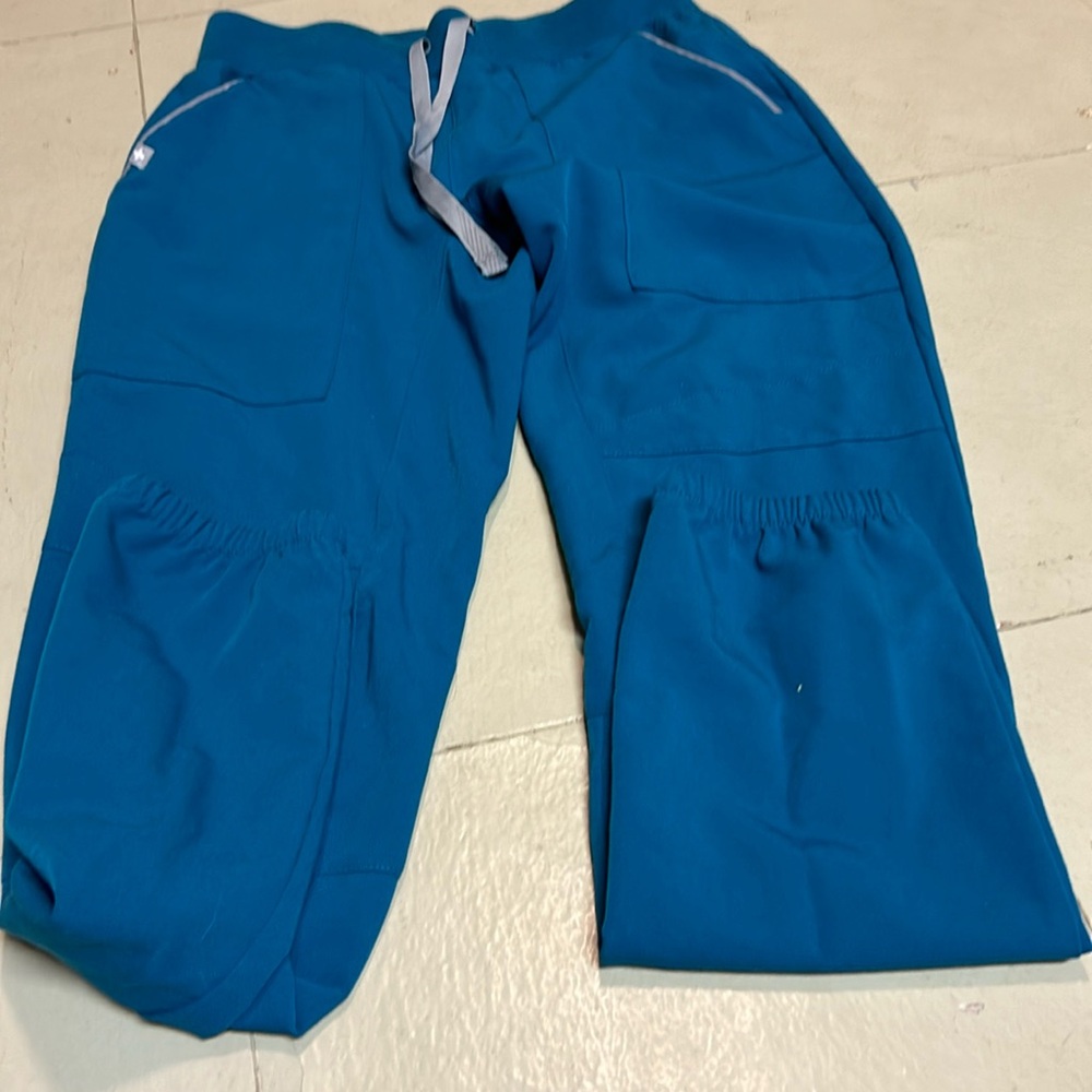 Figs I believe the color is pacific blue scrubs top and bottom are XXS.
